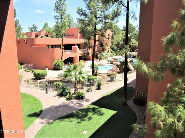 an aerial view of a house with a yard and lake view