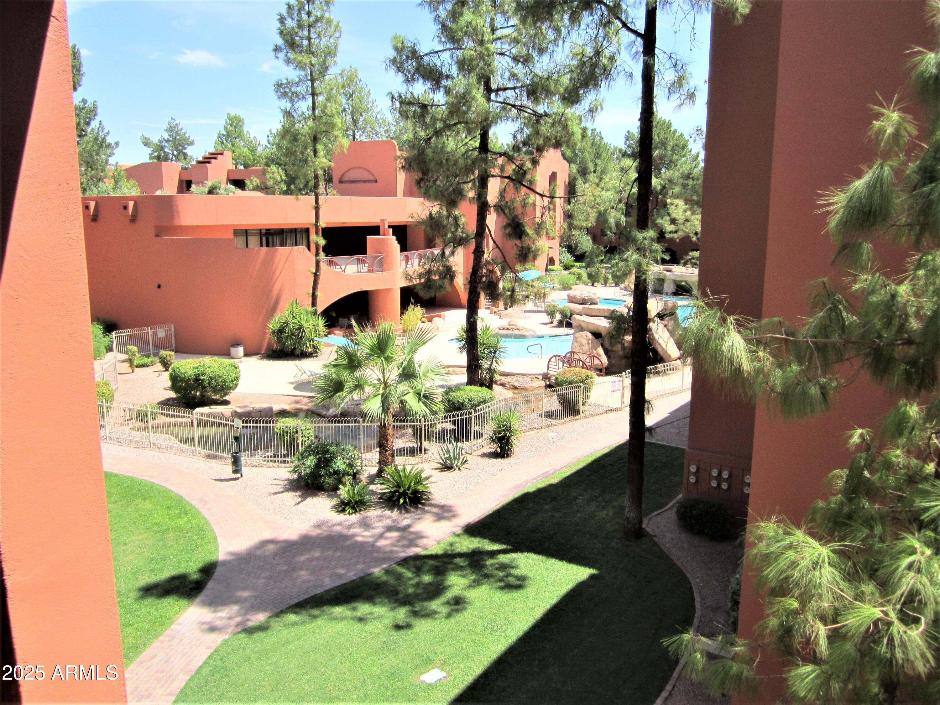 an aerial view of a house with a yard and lake view