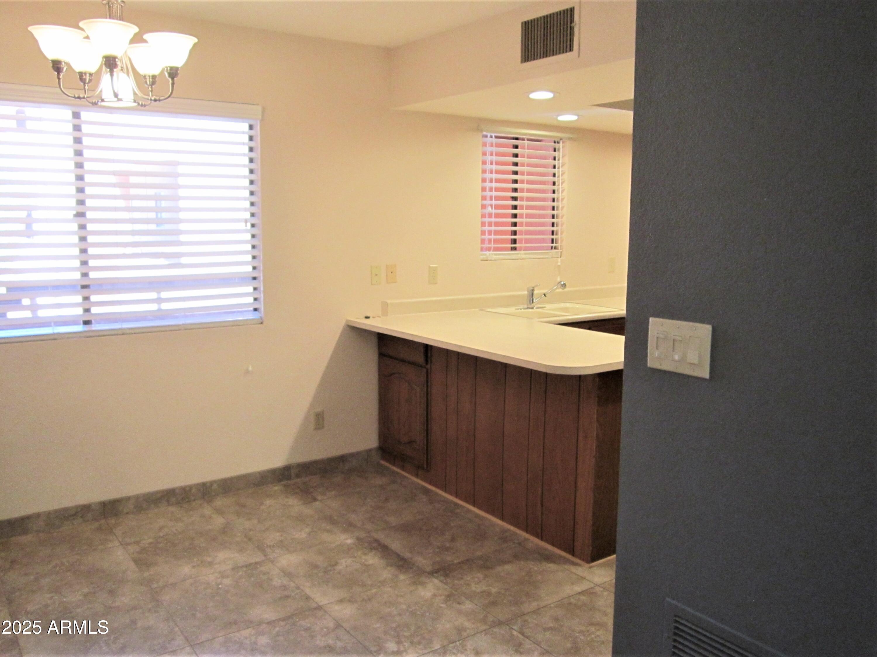 4303 East Cactus Road, Unit 310 Phoenix, AZ 85032 - Photo 4 of 27 a bathroom with a sink and a vanity