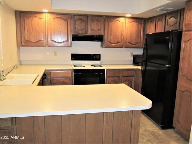 a kitchen with a refrigerator and a sink