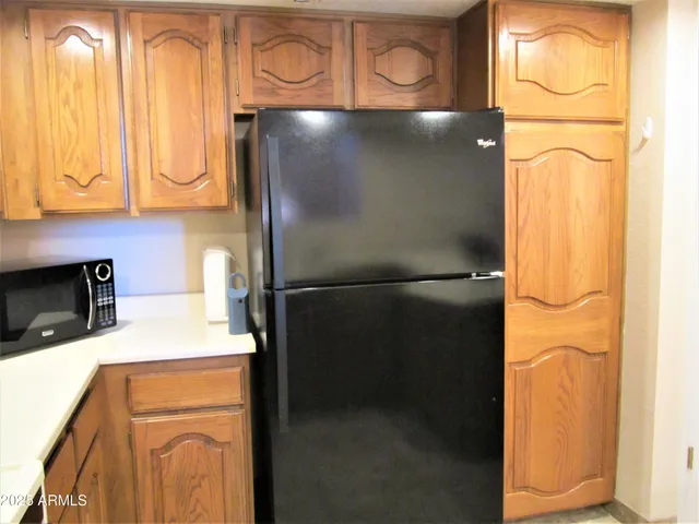 a close view of a refrigerator a stove and washer