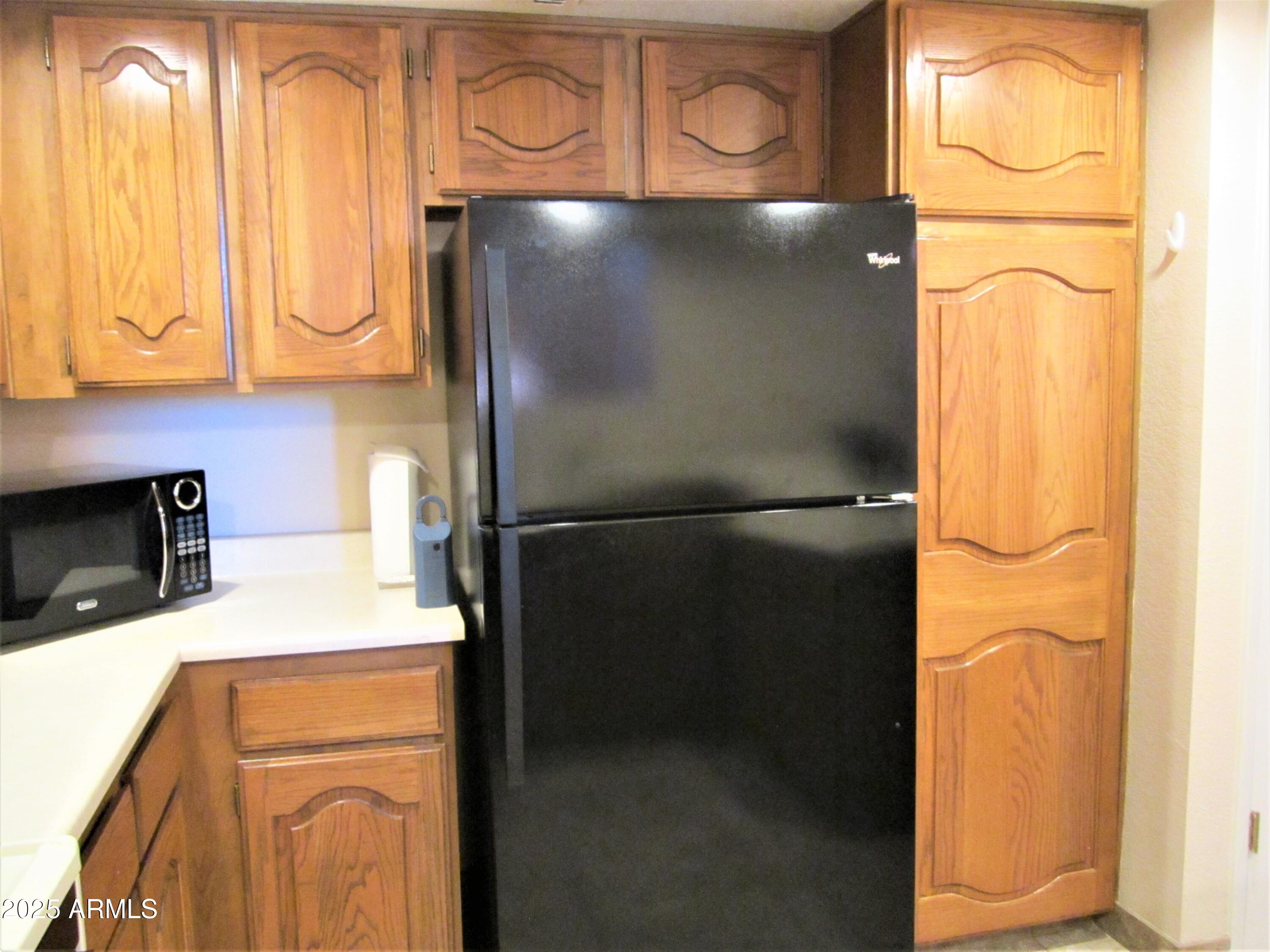 4303 East Cactus Road, Unit 310 Phoenix, AZ 85032 - Photo 6 of 27 a close view of a refrigerator a stove and washer