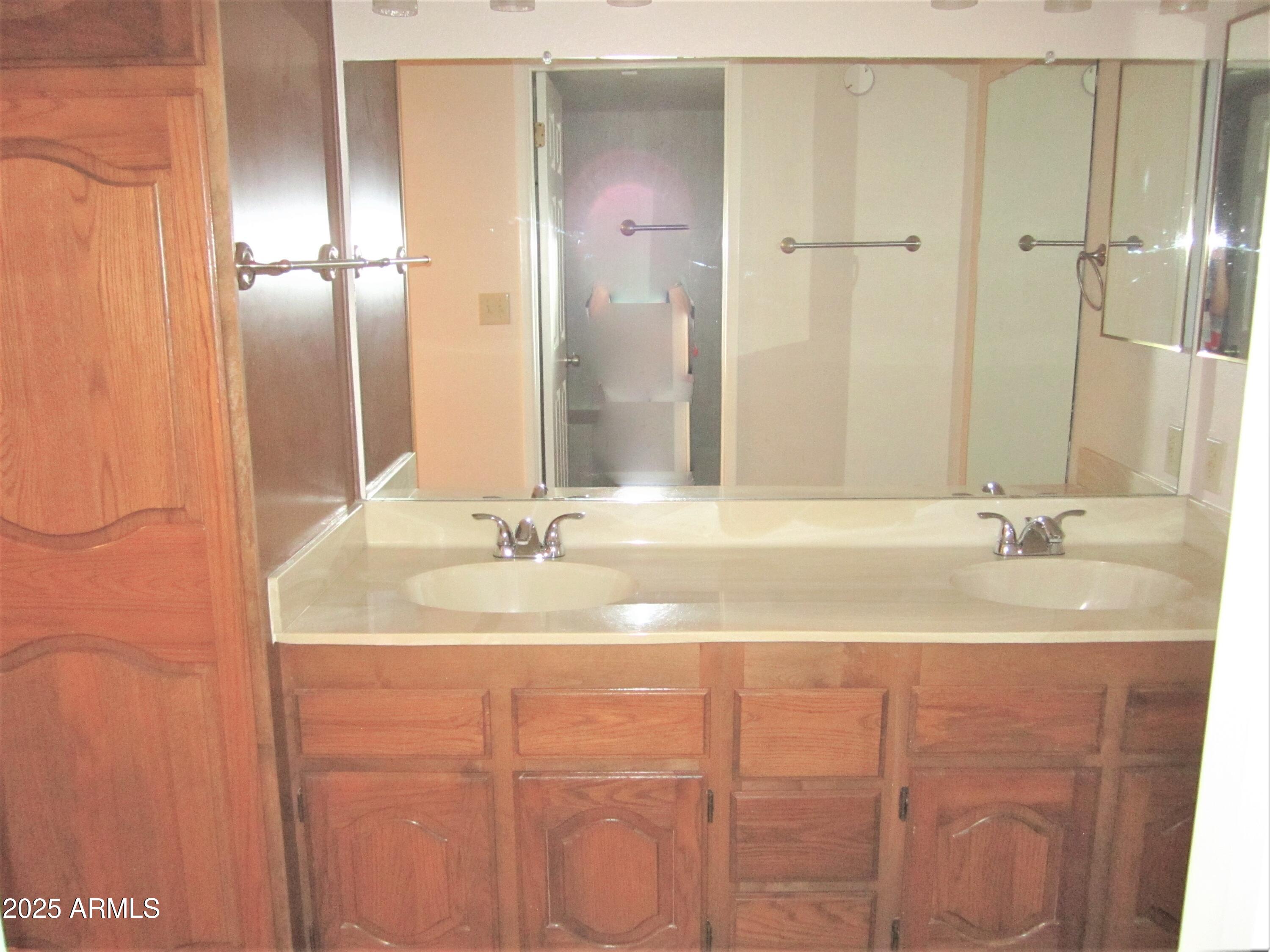 4303 East Cactus Road, Unit 310 Phoenix, AZ 85032 - Photo 8 of 27 a bathroom with a double vanity sink and a mirror