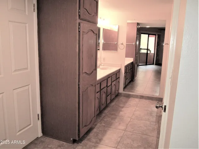 a view of a hallway with wooden floor and stairs