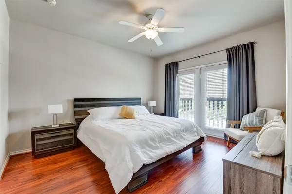a spacious bedroom with a bed and a window