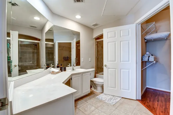 a large white room with a large window and furniture