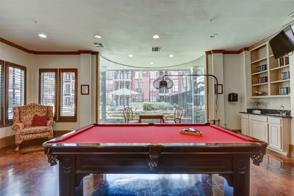 a room with pool table and windows