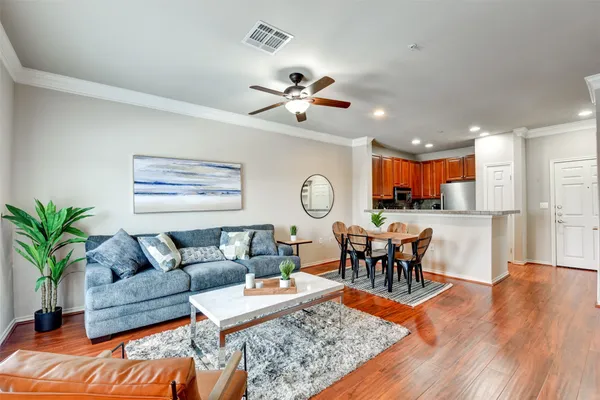a living room with furniture potted plant and window