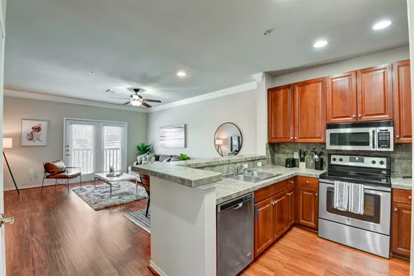 a kitchen with a stove a sink and a microwave