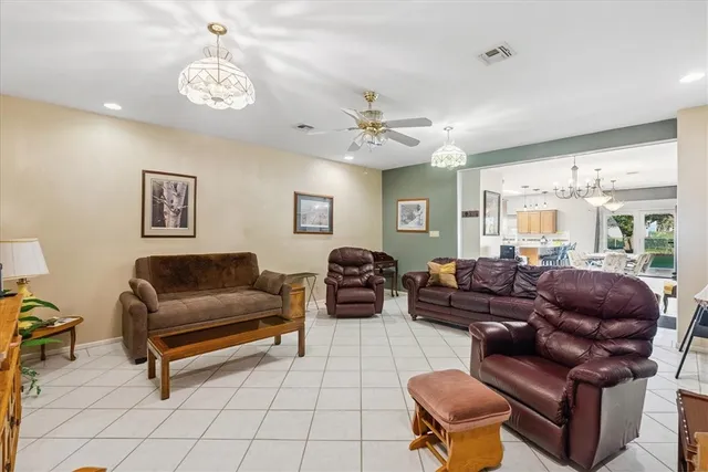 a living room with furniture ceiling fan and a window