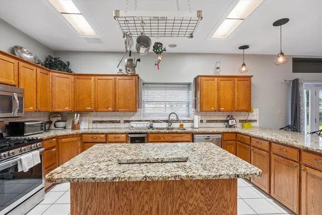 a kitchen with center island table and chairs in it