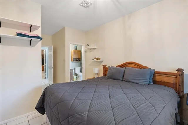 a bathroom with a granite countertop sink mirror vanity and toilet