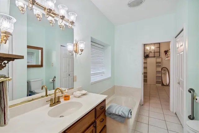a spacious bathroom with a bathtub and mirror