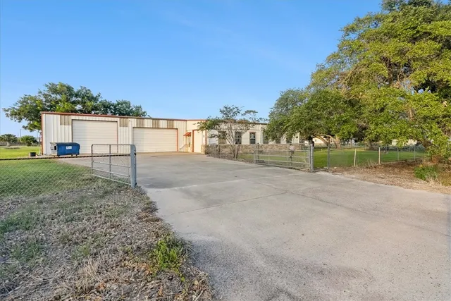 a view of a dirt road with a building in the background