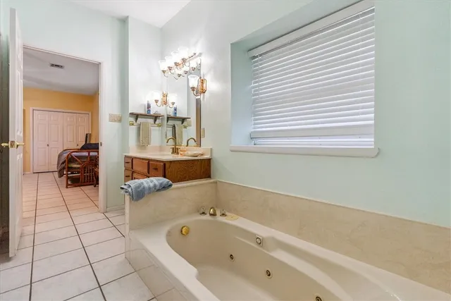 a bedroom with bed and a chandelier