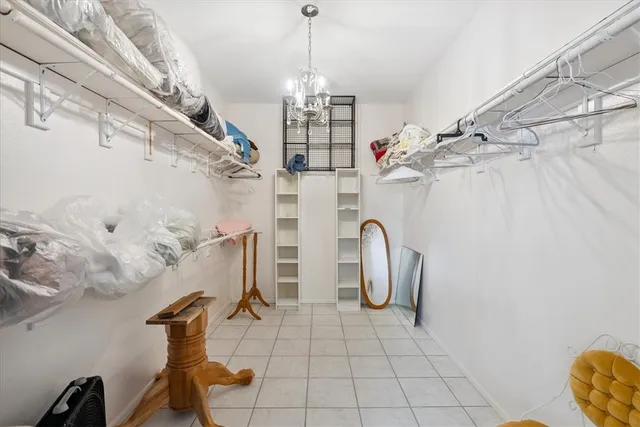 a living room with furniture and a baby crib