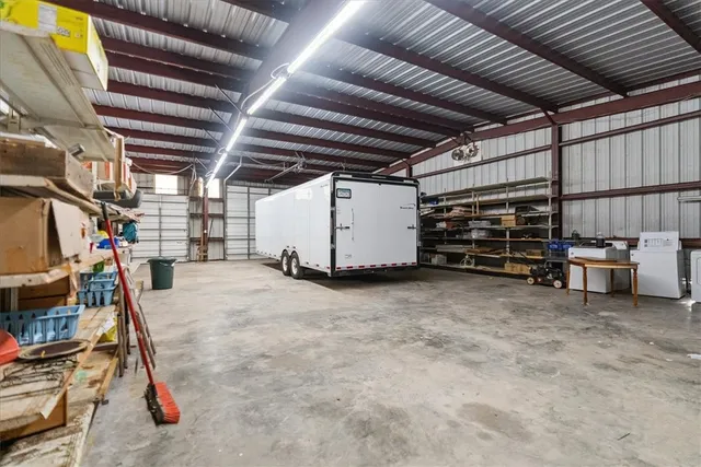 a living room with furniture gym equipment and large windows