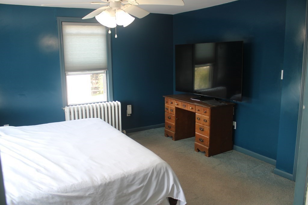 118 Eastern Avenue Gloucester, MA 01930 - Photo 14 of 40 a bedroom with a bed and a television