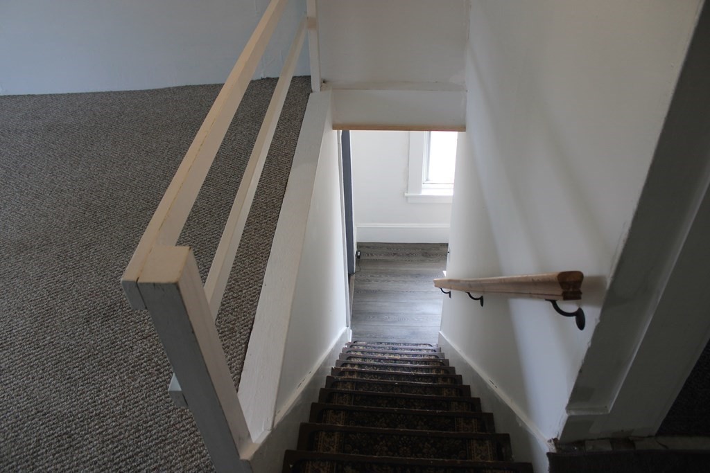 118 Eastern Avenue Gloucester, MA 01930 - Photo 20 of 40 a view of staircase with white walls and a window