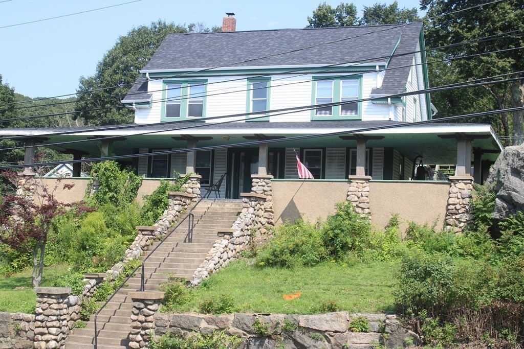 118 Eastern Avenue Gloucester, MA 01930 - Photo 2 of 40 a view of a white house with large windows and a table and chairs in a yard