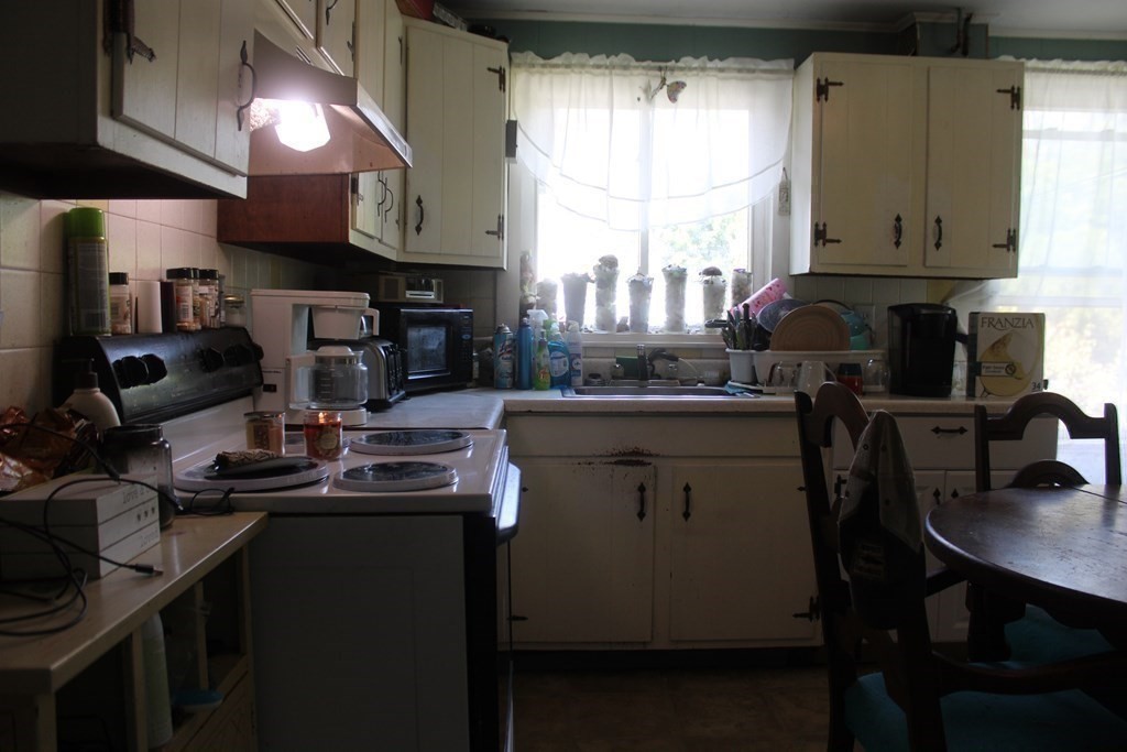 118 Eastern Avenue Gloucester, MA 01930 - Photo 25 of 40 a kitchen with a sink a stove and cabinets