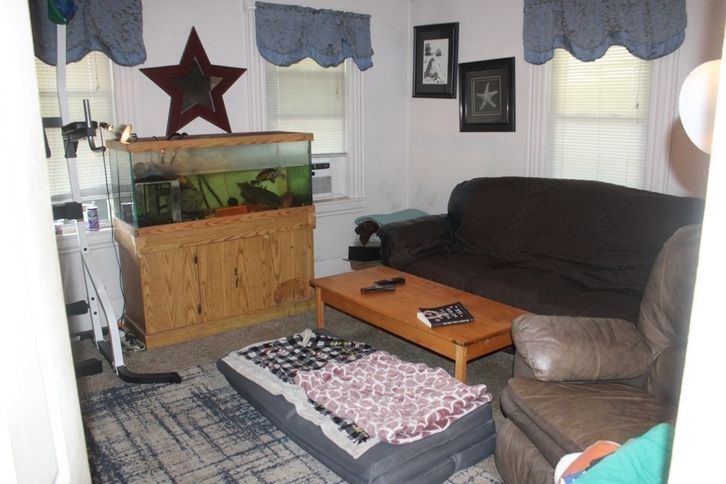 118 Eastern Avenue Gloucester, MA 01930 - Photo 27 of 40 a living room with furniture and a rug