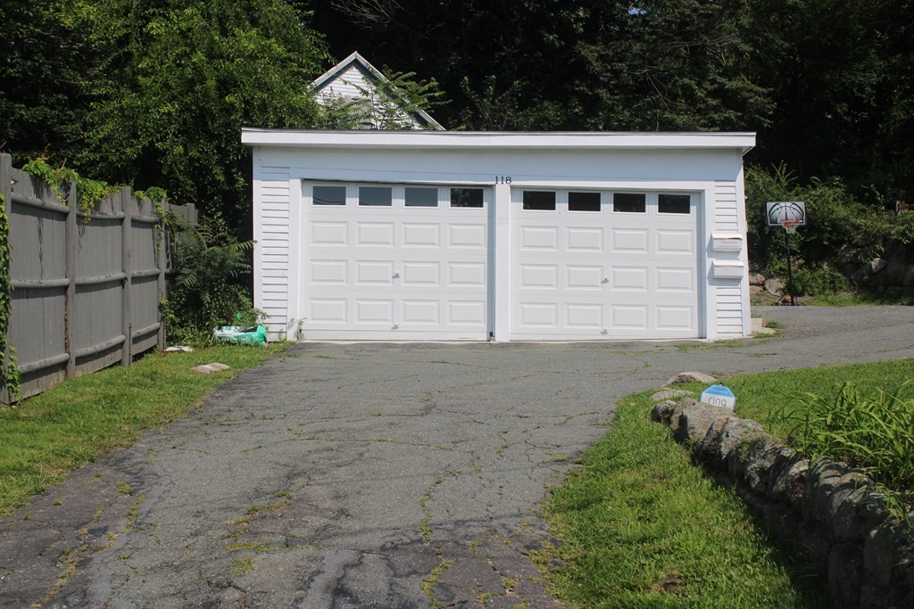 118 Eastern Avenue Gloucester, MA 01930 - Photo 3 of 40 a front view of a house with a yard and garage