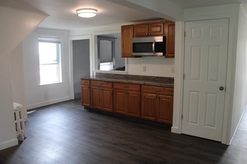 118 Eastern Avenue Gloucester, MA 01930 - Photo 6 of 40 a room with wooden floors and wooden cabinets