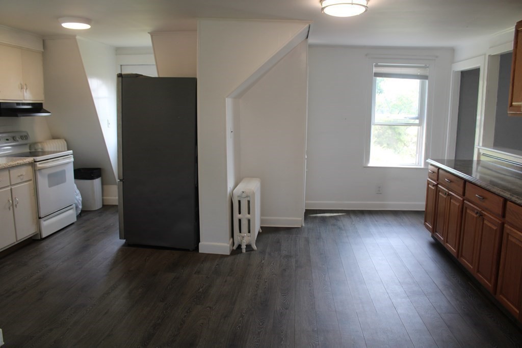 118 Eastern Avenue Gloucester, MA 01930 - Photo 8 of 40 a kitchen with stainless steel appliances a refrigerator and a stove top oven