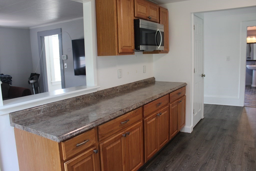118 Eastern Avenue Gloucester, MA 01930 - Photo 9 of 40 a kitchen with stainless steel appliances granite countertop a sink microwave and stove
