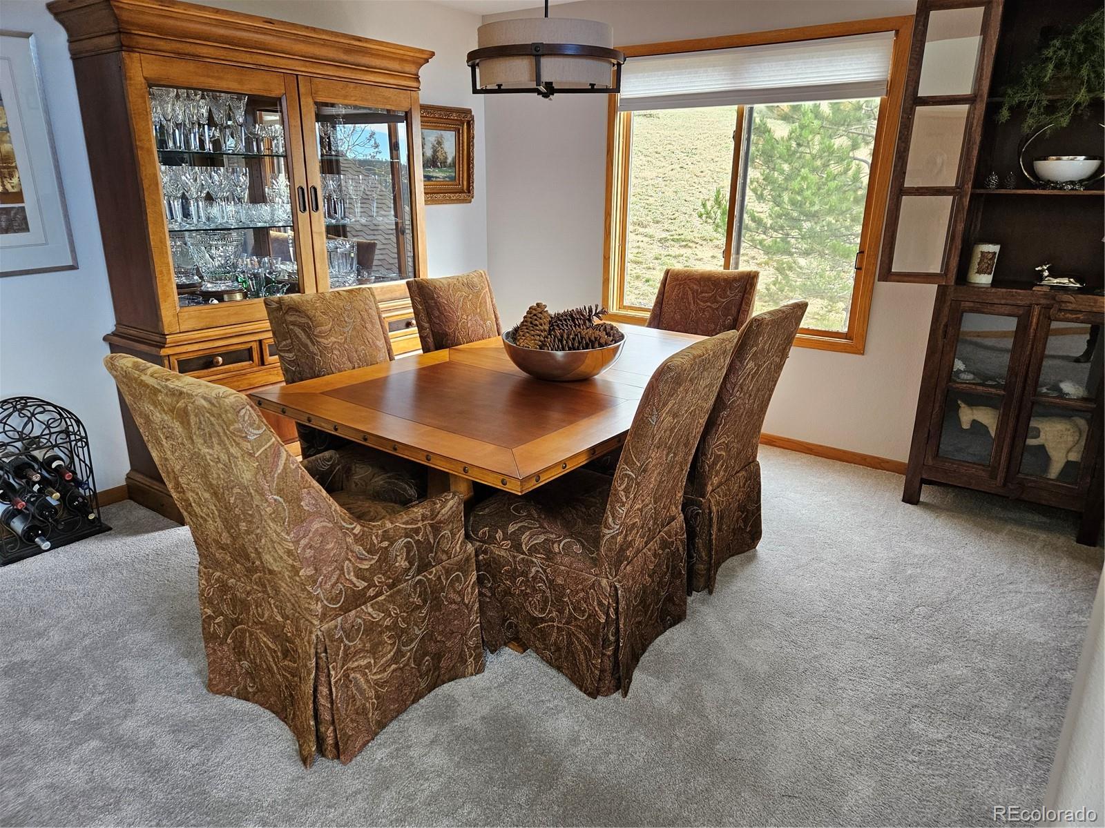 386 Monte Vista Road Golden, CO 80401 - Photo 13 of 32 a view of a dining room with furniture window and outside view