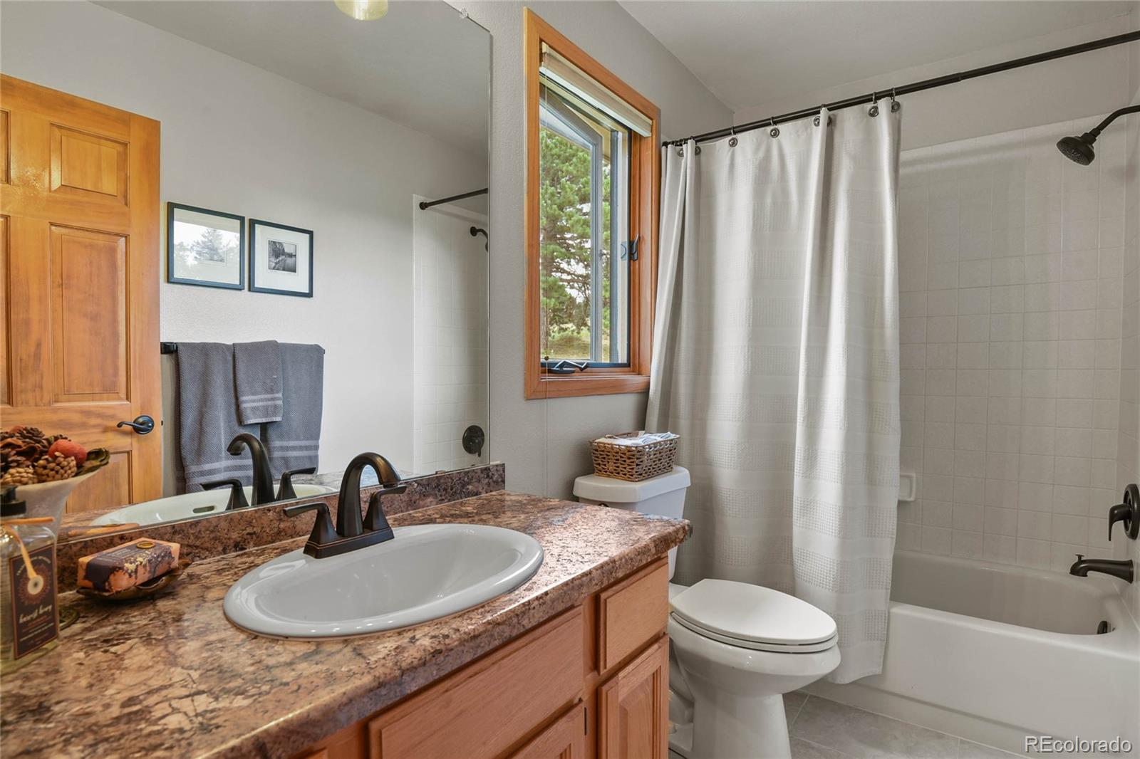 386 Monte Vista Road Golden, CO 80401 - Photo 23 of 32 a bathroom with a granite countertop sink and a mirror