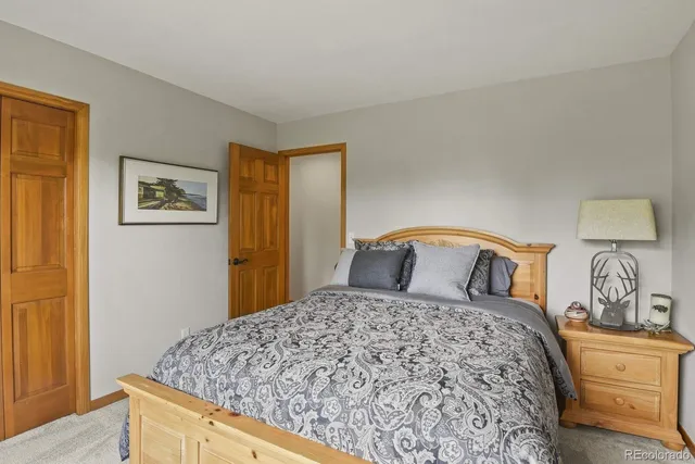 a bedroom with a large bed and a dresser