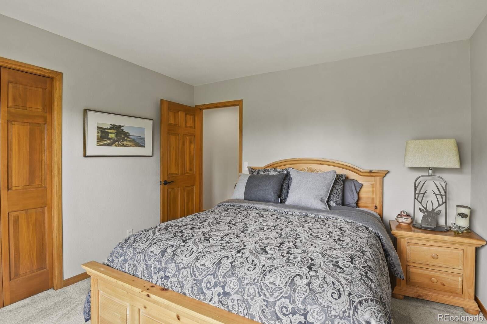386 Monte Vista Road Golden, CO 80401 - Photo 24 of 32 a bedroom with a large bed and a dresser