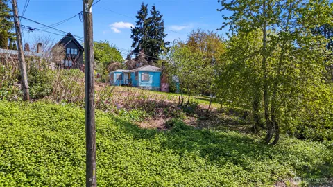 a view of a house with a tree in the background