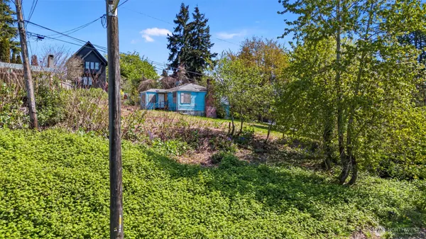 a view of a house with a tree in the background
