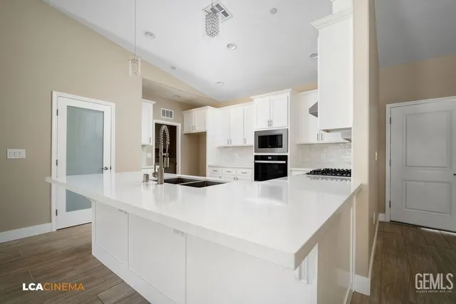 a kitchen with stainless steel appliances a sink and a refrigerator