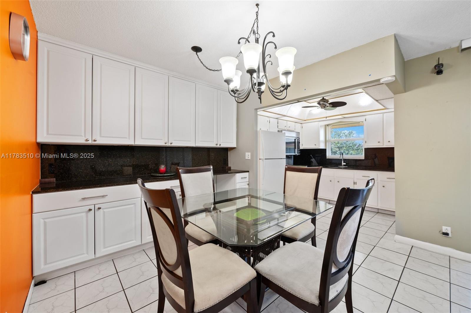5300 Washington Street, Unit G323 Hollywood, FL 33021 - Photo 11 of 34 a view of a dining room with furniture and a chandelier
