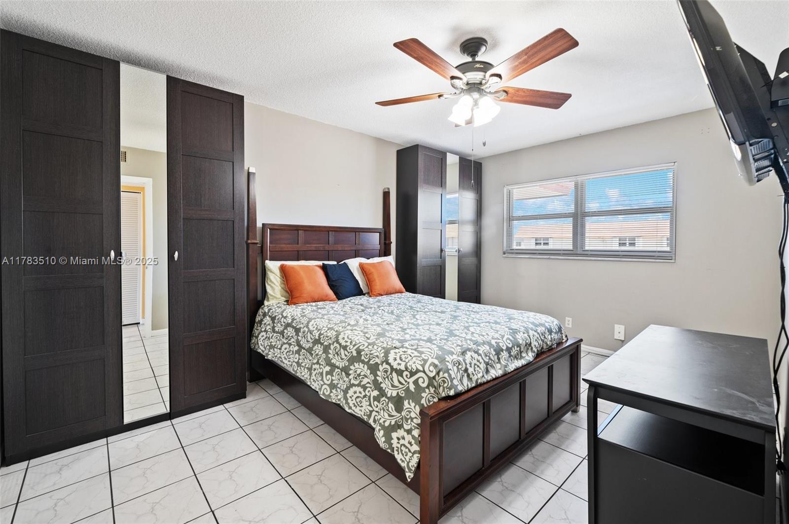 5300 Washington Street, Unit G323 Hollywood, FL 33021 - Photo 16 of 34 a bedroom with a bed and a chandelier