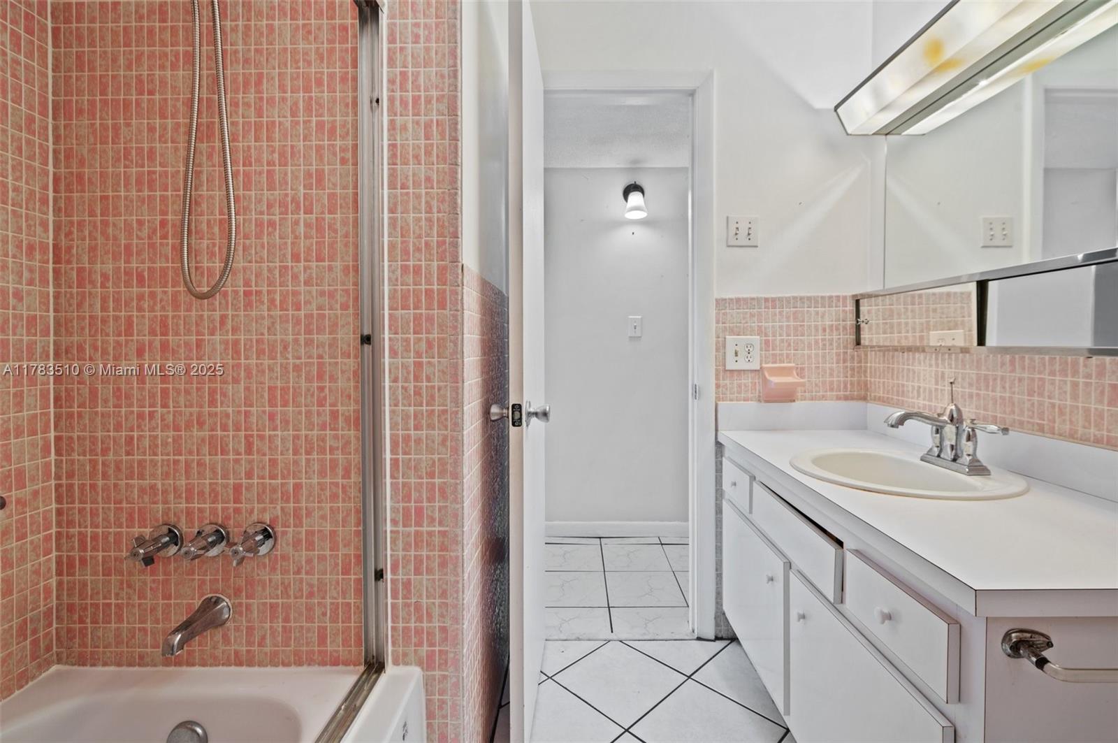 5300 Washington Street, Unit G323 Hollywood, FL 33021 - Photo 24 of 34 a bathroom with a sink and a mirror