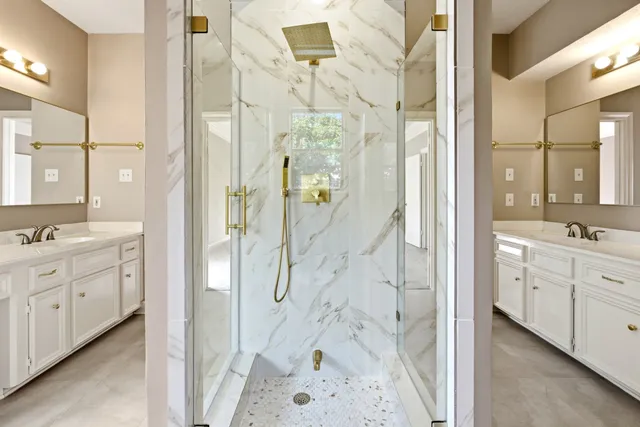 a bathroom with a glass shower door