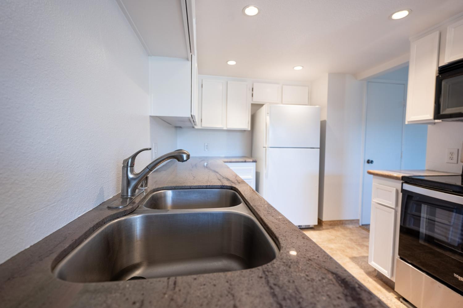 3701 Colonial Drive, Unit 89 Modesto, CA 95356 - Photo 2 of 20 a kitchen with a sink cabinets and stainless steel appliances