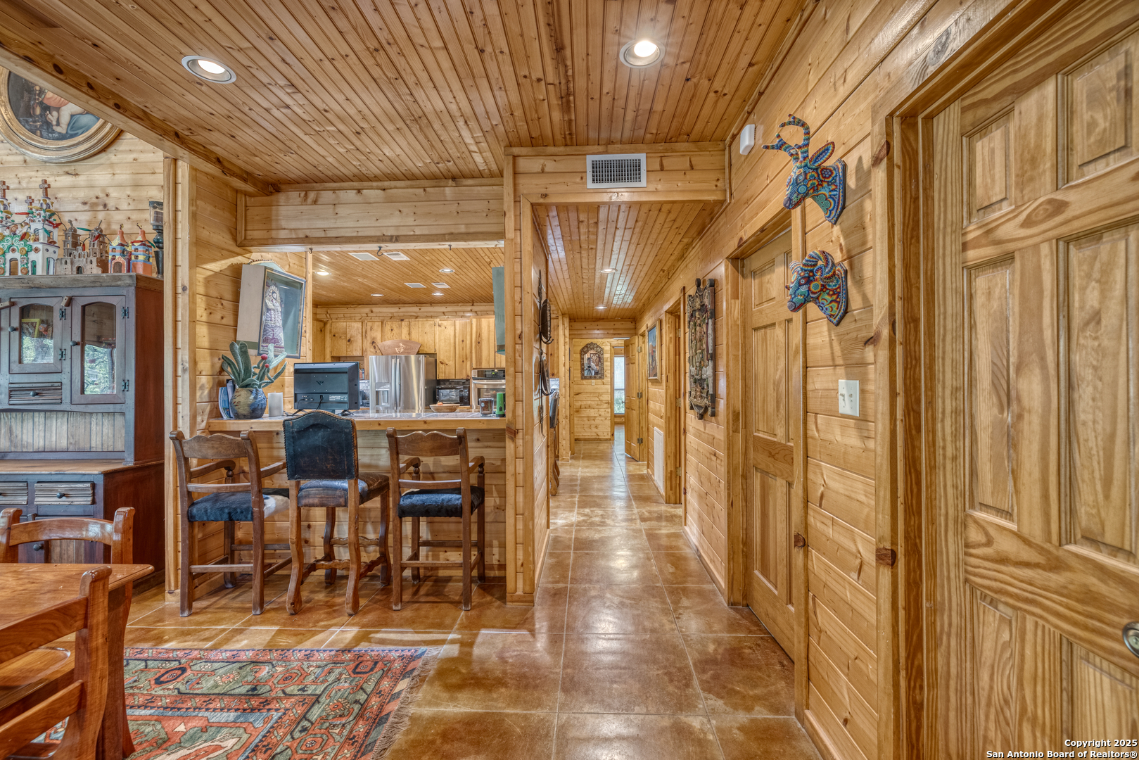 4983 Ranch Road 1051 Uvalde, TX 78801 - Photo 11 of 72 a dining room with lots of wooden furniture and glass door