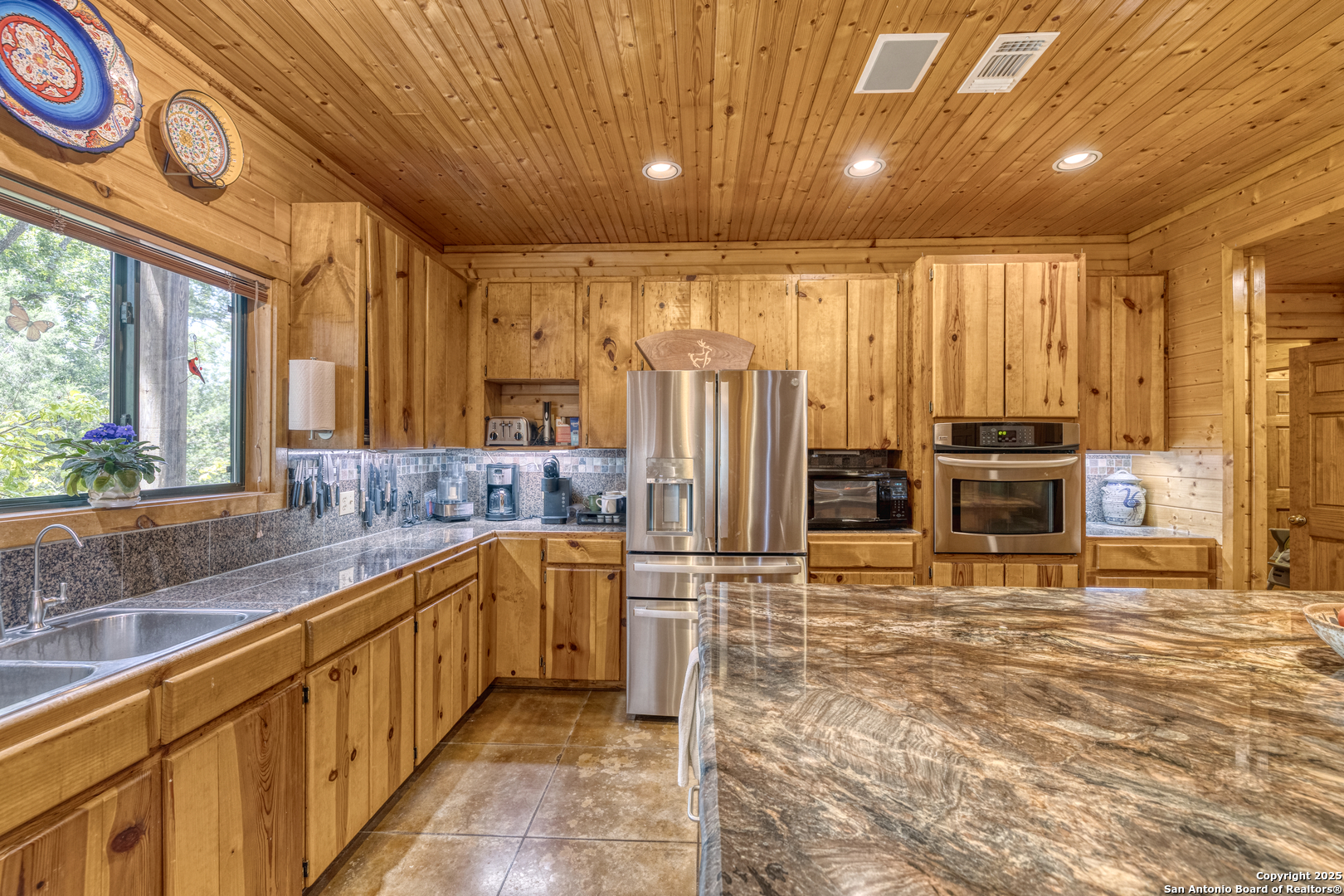 4983 Ranch Road 1051 Uvalde, TX 78801 - Photo 16 of 72 a large kitchen with stainless steel appliances granite countertop a sink and cabinets