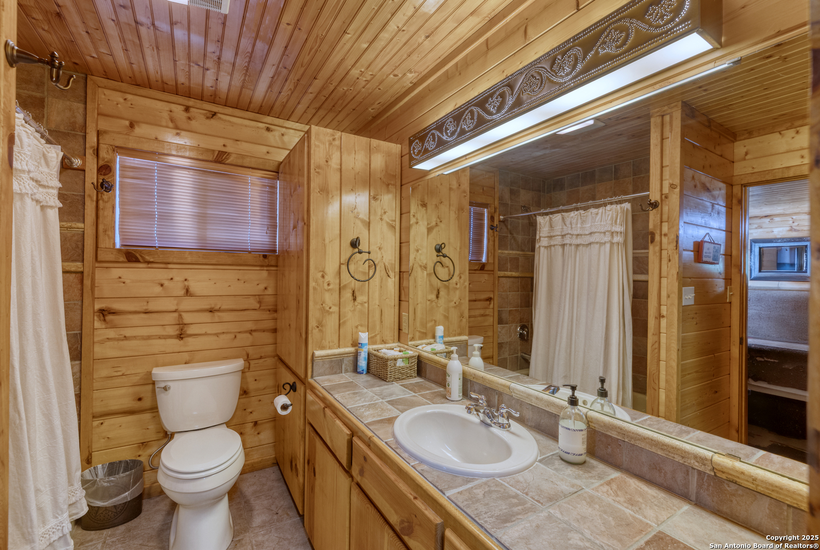 4983 Ranch Road 1051 Uvalde, TX 78801 - Photo 39 of 72 a bathroom with a granite countertop sink toilet and shower