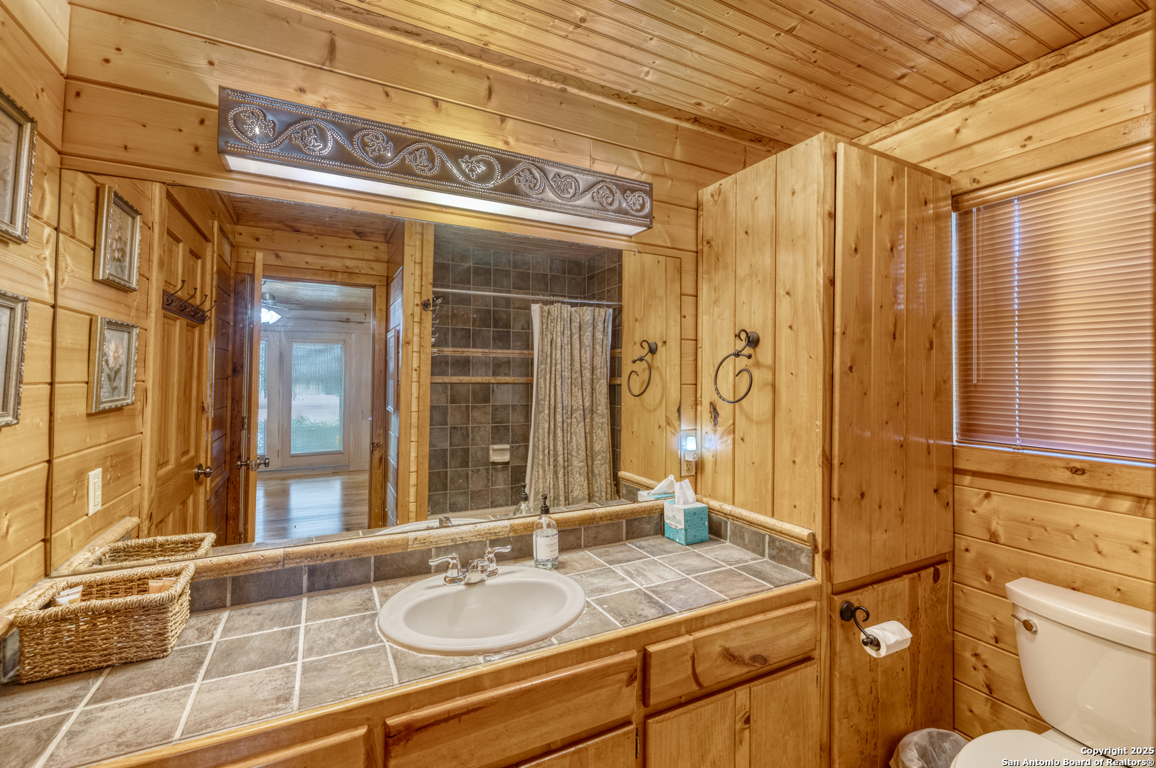 4983 Ranch Road 1051 Uvalde, TX 78801 - Photo 41 of 72 a bathroom with a granite countertop sink and a mirror
