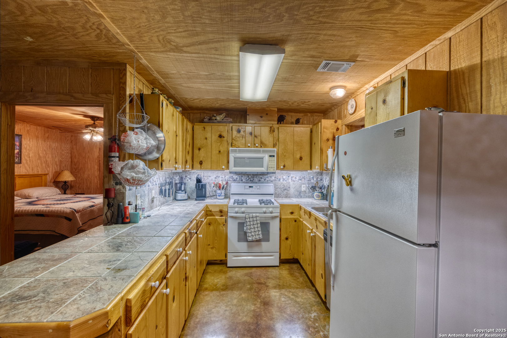 4983 Ranch Road 1051 Uvalde, TX 78801 - Photo 46 of 72 a kitchen with stainless steel appliances granite countertop a refrigerator a stove and a sink