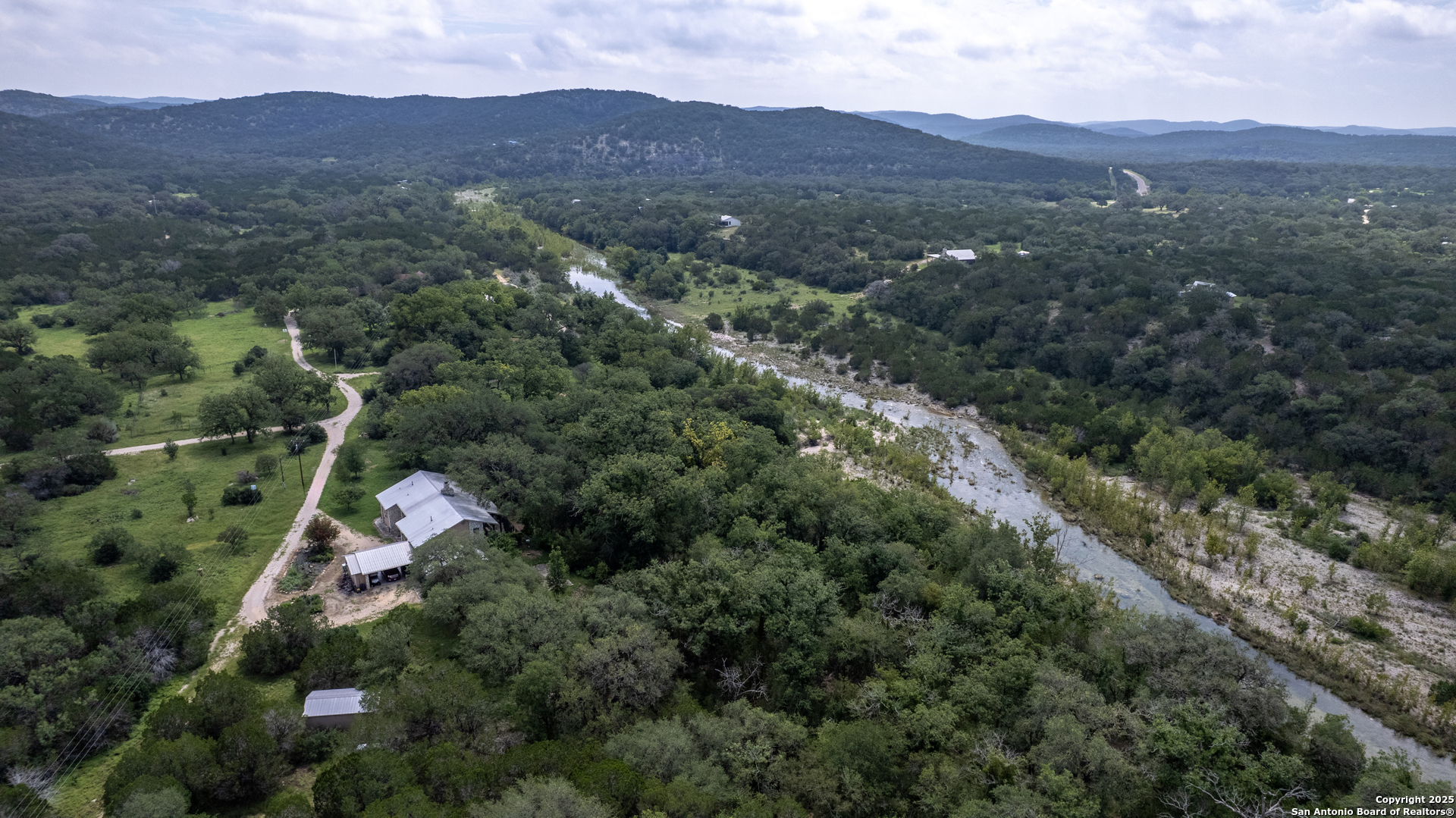 4983 Ranch Road 1051 Uvalde, TX 78801 - Photo 68 of 72 an aerial view of a house with a yard and mountain view