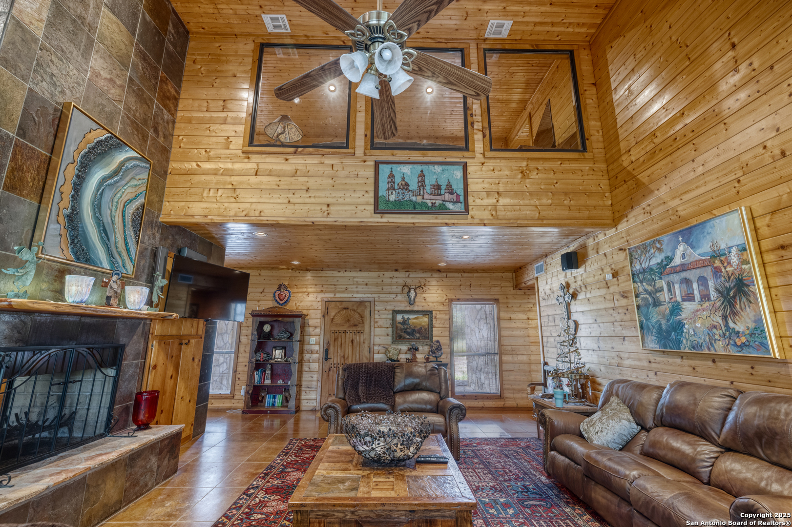 4983 Ranch Road 1051 Uvalde, TX 78801 - Photo 8 of 72 a living room with furniture a flat screen tv and a fireplace