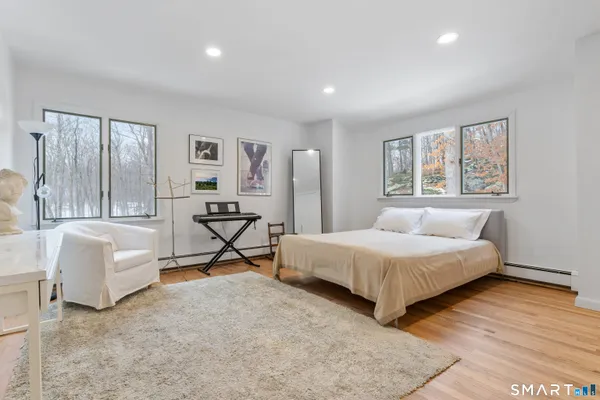 a bedroom with a bed and a couch